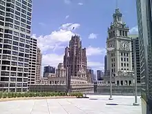Image of clock tower and another building tower from the terrace of a tall building