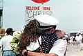 A sailor from the USS Harry W. Hill' returning from a deployment on 8 June 1991
