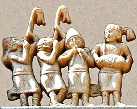 Detail of the foreigners, in Greek dress and playing carnyxes and aolus flute.