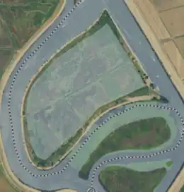 Aerial image of an island almost totally oversconced by water.