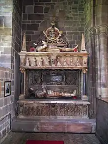Tomb of two Sir Edward Littletons, father and son. East wall of north chancel aisle. Lower stage: Sir Edward Littleton (died 1610) and his wife Margaret Devereux. Upper stage: Sir Edward (died 1629), and his wife Mary Fisher. Their son, also Sir Edward, became the first baronet in 1627.