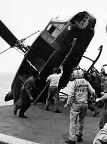 South Vietnamese helicopter is pushed over the side of USS Okinawa during Operation Frequent Wind in April 1975.