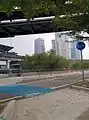 Bike crossing with sign and blue route at northern part of Southwest Dedicated Bicycle Highway, located near POS Malaysia headquarter.