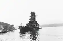 a heavily damaged Haruna, having sunk from the stern, several days after coming under attack at her moorings